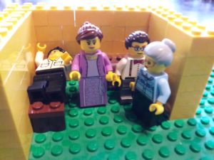 Small Lego room crowded with two male and two female Lego minifigures